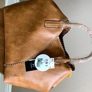 Le Miel two in one purse, has holder strap and dust cover.